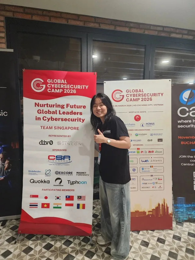Kar Wei in front of the Global Cybersecurity Camp 2026 banners, with Hexcore Labs among the sponsors