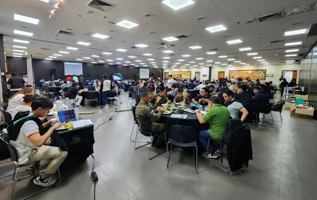 Over 140 students from 30 universities seated at tables with laptops during the Cybersecurity CTF Competition and AI Hackathon at the Asian Institute of Managem