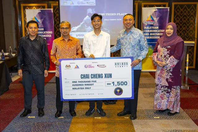 Five people holding a large cheque for 1,500 ringgit at an awards ceremony indoors